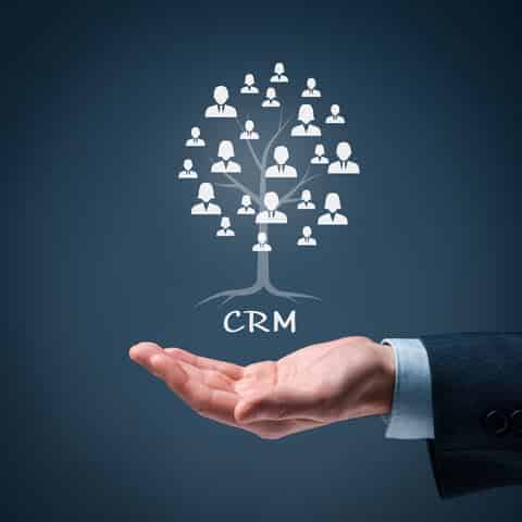 businessman hand gesturing to customer relationship manager CRM symbols