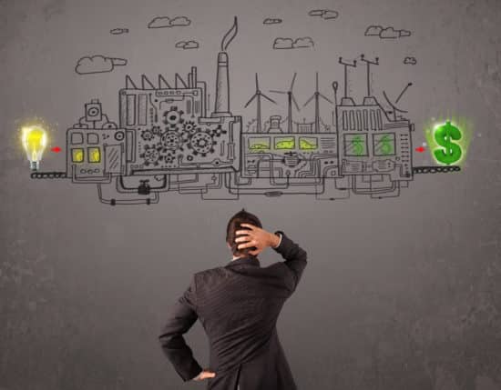 Business man looking at factory that makes money from ideas concept